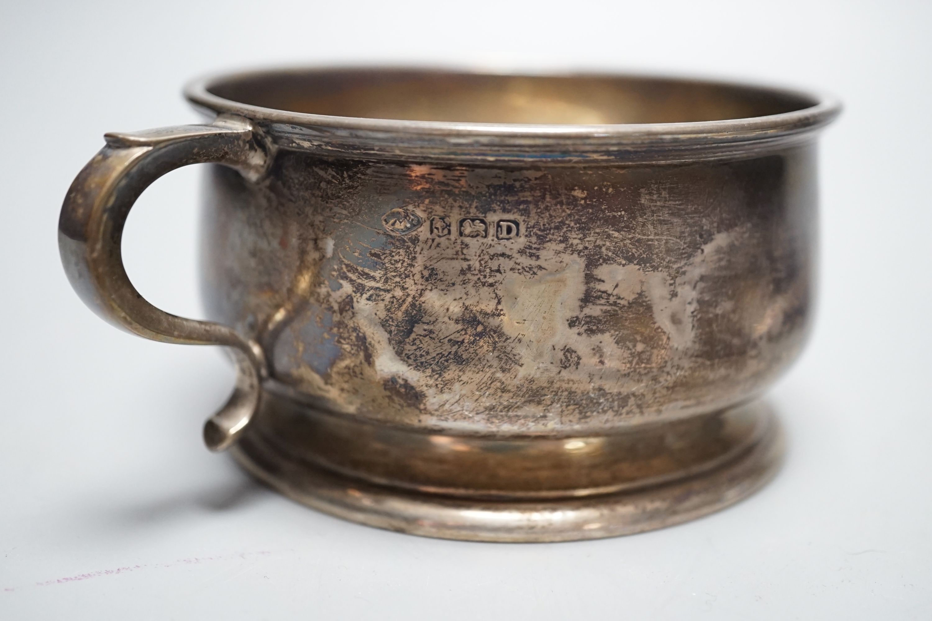 A silver two handled bowl, a silver mounted hand mirror, two silver and mother of pearl fruit knives, a silver preserve spoon and enamelled compact decorated with a dog.